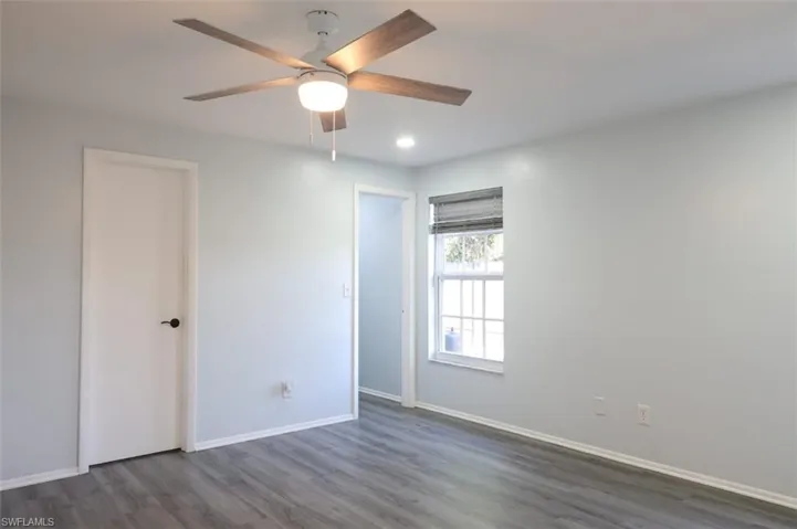 Unfurnished bedroom featuring dark wood finished floors, a ceiling fan, and recessed lighting