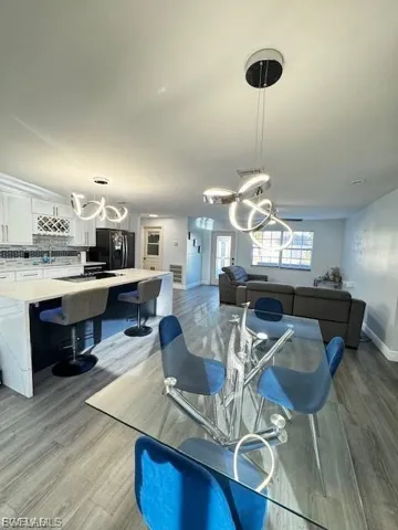 Dining space featuring a chandelier and light wood-style flooring