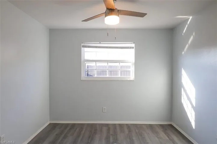 Spare room featuring wood finished floors and ceiling fan