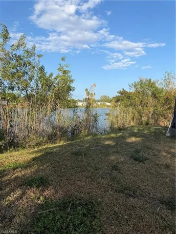 View of green lawn with a water view