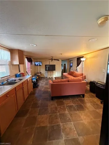 Living area with stone finish floors and a textured ceiling