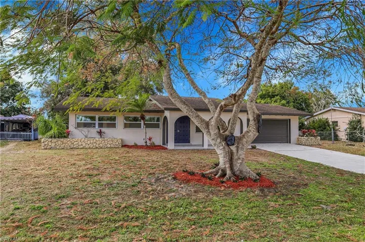 Ranch style home  featuring stucco siding, concrete driveway, and an attached garage