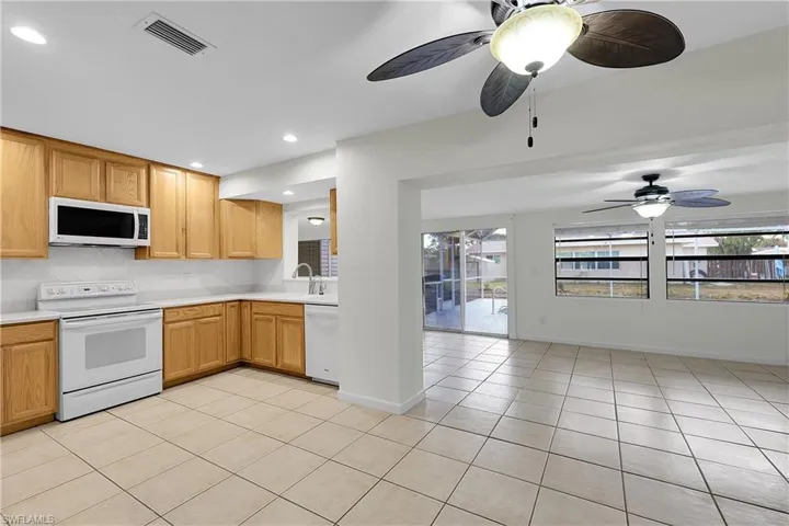 View from family into the dining area with kitchen in the background
