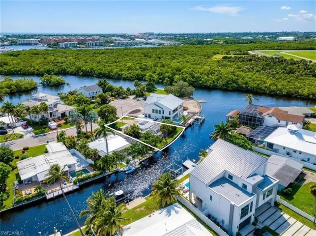Waterfront property with canal frontage, surrounded by tropical foliage
