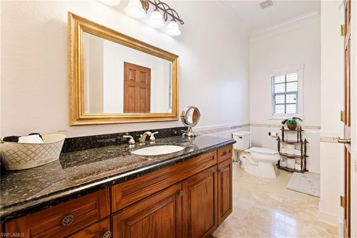 3rd Bathroom with visible vents, toilet, vanity, tile walls, and crown molding