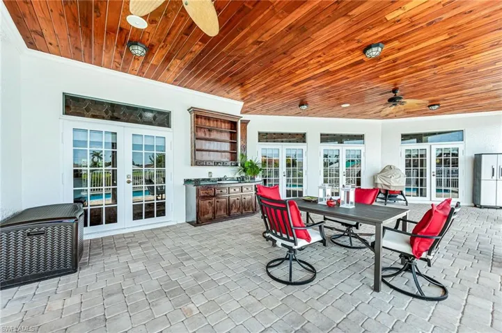 View of patio / terrace with a ceiling fan, exterior kitchen, and french doors