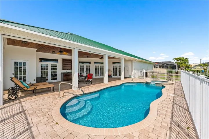 View of pool featuring french doors, a patio, a ceiling fan, and fence