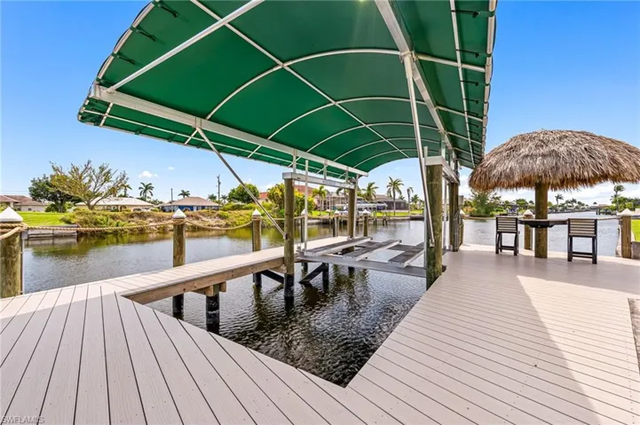 View of dock with boat lift and a water view