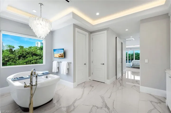Primary bath with free standing jet tub and double water closets