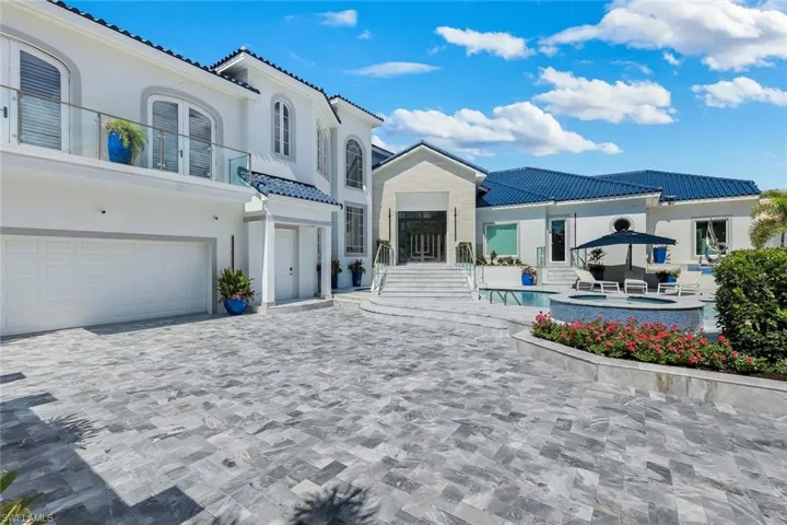 Paved drive, lower level access, front door entry and pool access door