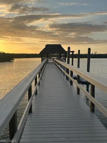 Tiki hust at end of new boardwalk; kayak launching raft to right
