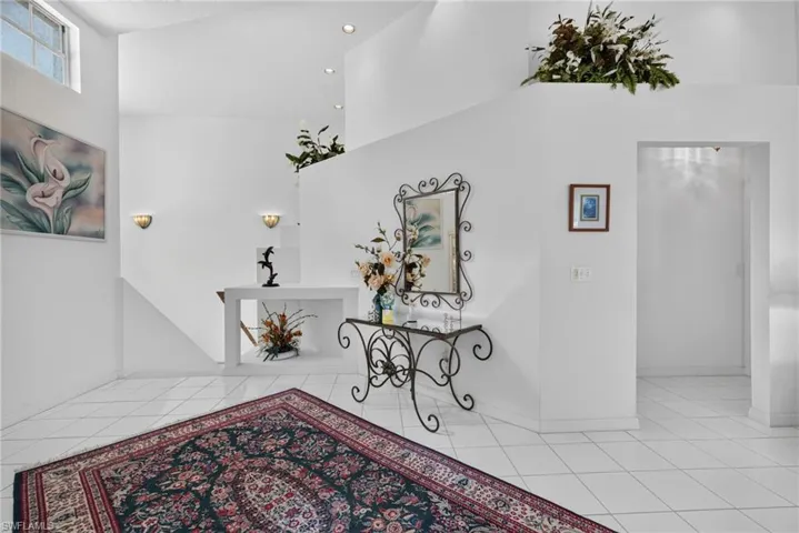 Double height foyer: Stairs to left from front door and also garage
