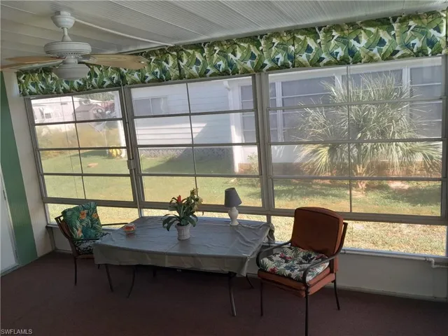 Sunroom / solarium featuring ceiling fan and a healthy amount of sunlight