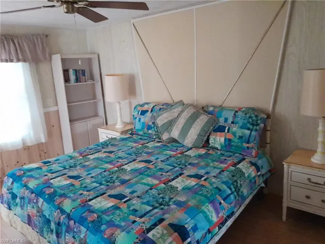 Bedroom with ceiling fan and wood-type flooring