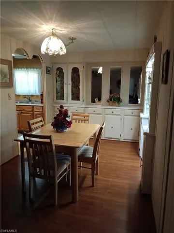 Dining space featuring a notable chandelier, sink, and hardwood / wood-style floors
