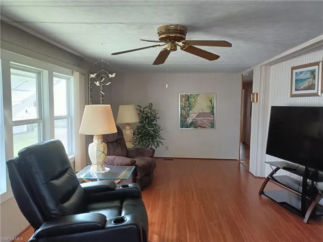 Living room featuring hardwood / wood-style floors and ceiling fan