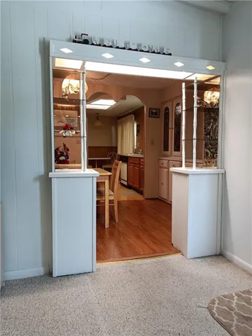 Kitchen with light hardwood / wood-style flooring and white dishwasher