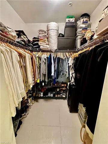 Walk in closet featuring tile floors