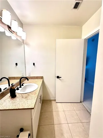 Bathroom featuring tile flooring and vanity