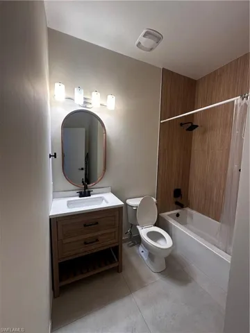 Full bathroom with  shower combination, oversized vanity, and toilet
