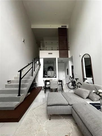 Tiled living room with a high ceiling