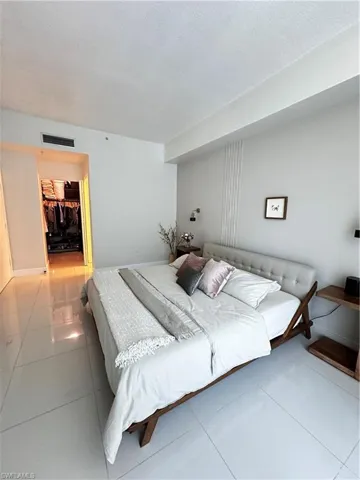 Bedroom featuring tile floors, a walk in closet, and a closet