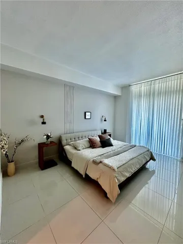 Tiled bedroom featuring a textured ceiling