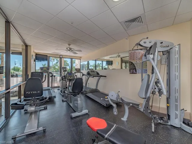 Gym featuring a drop ceiling and ceiling fan