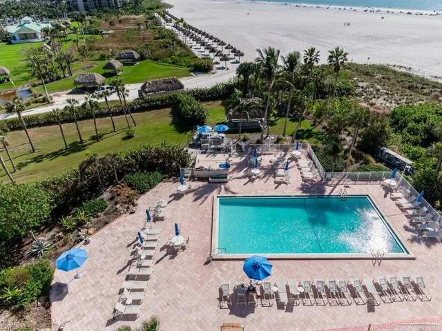 View of swimming pool with a water view and a patio