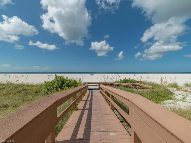 Surrounding community with a view of the beach and a water view