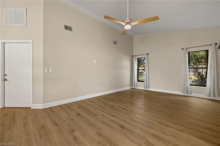 Spare room featuring light wood-style flooring, visible vents, and a healthy amount of sunlight