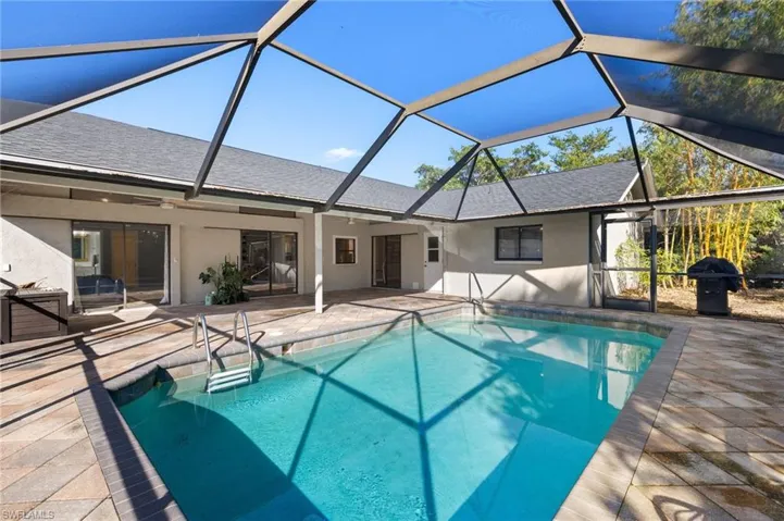 Outdoor pool featuring a lanai and a patio