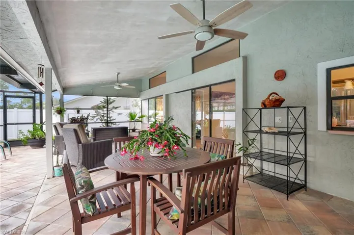Sunroom featuring vaulted ceiling and a textured wall