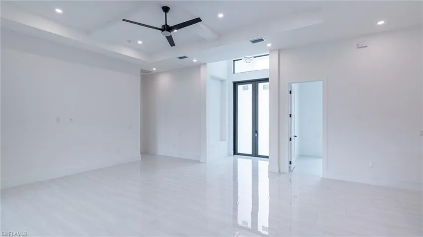 Spacious interior featuring sleek tile flooring and a contemporary ceiling fan