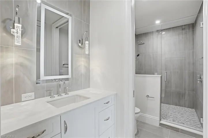 Full bath with vanity and a stall shower