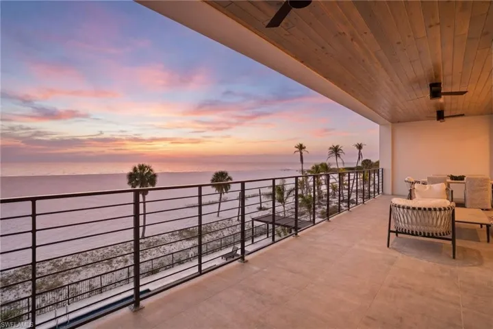 Balcony with ceiling fan and a water view