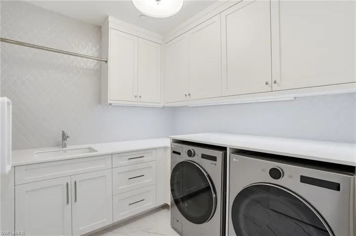Laundry area with washer and clothes dryer and cabinet space