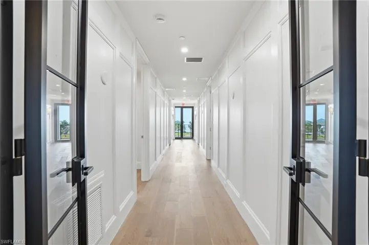 Corridor featuring light wood-type flooring and recessed lighting