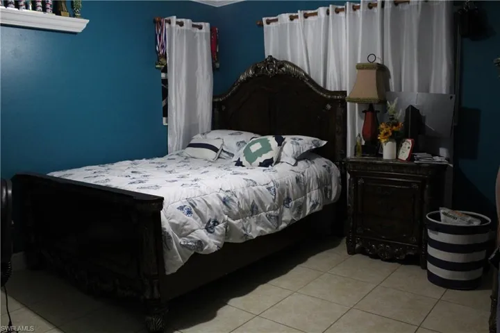 Bedroom with light tile patterned floors
