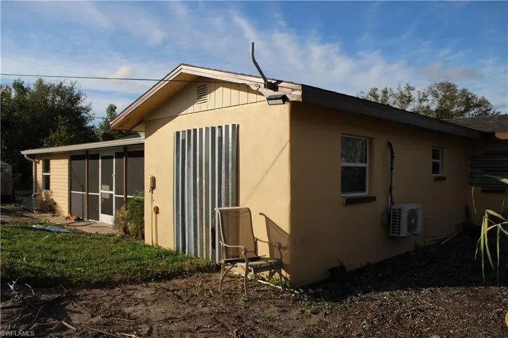 View of home's exterior with a sunroom and stucco siding