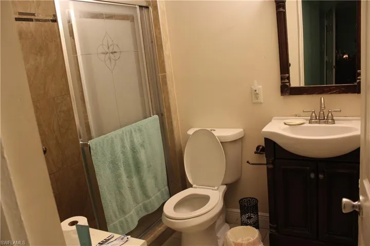 Full bathroom with vanity and a stall shower