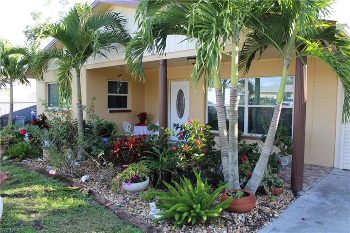 Property entrance with stucco siding and covered porch