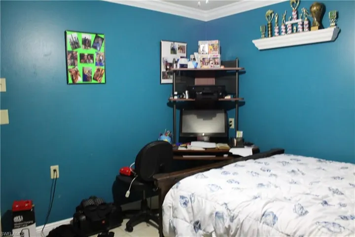 Bedroom featuring crown molding