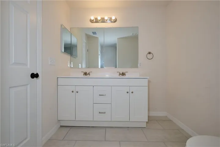 Bathroom featuring vanity and tile patterned floors