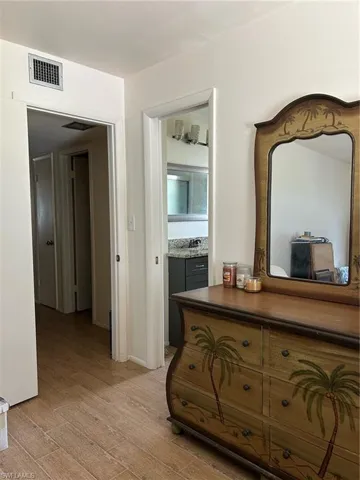 Hallway with sink and light wood-type flooring