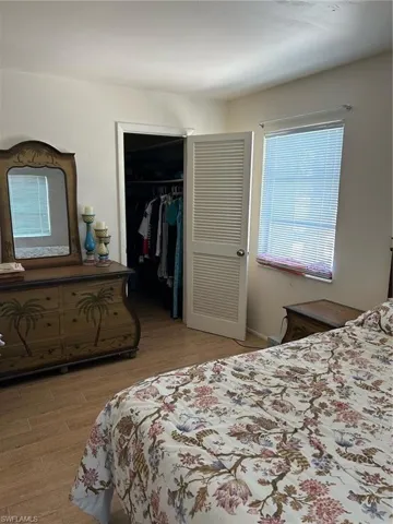 Bedroom with a closet, hardwood / wood-style flooring, and a spacious closet
