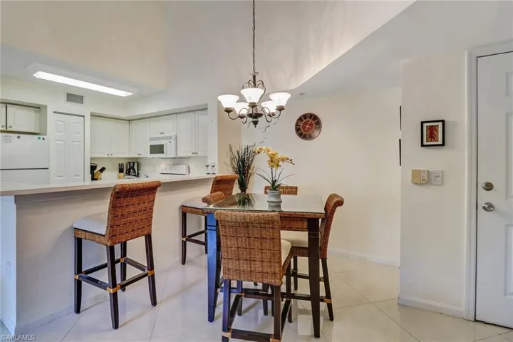 Dining room featuring a chandelier and light tile patterned flooring