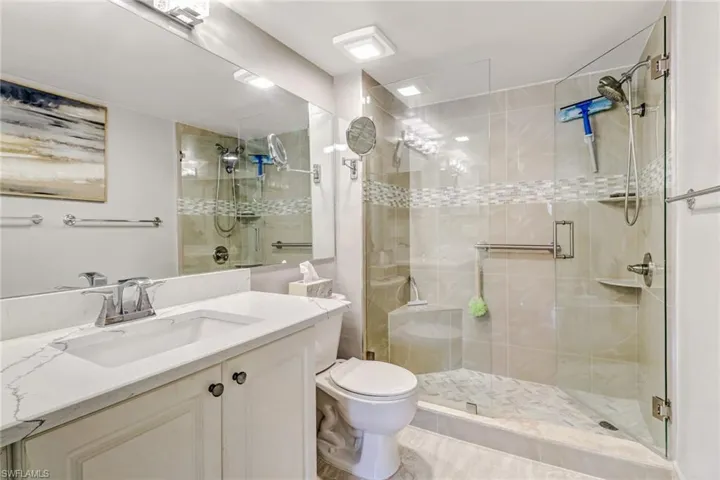 Full bath with vanity and a shower stall