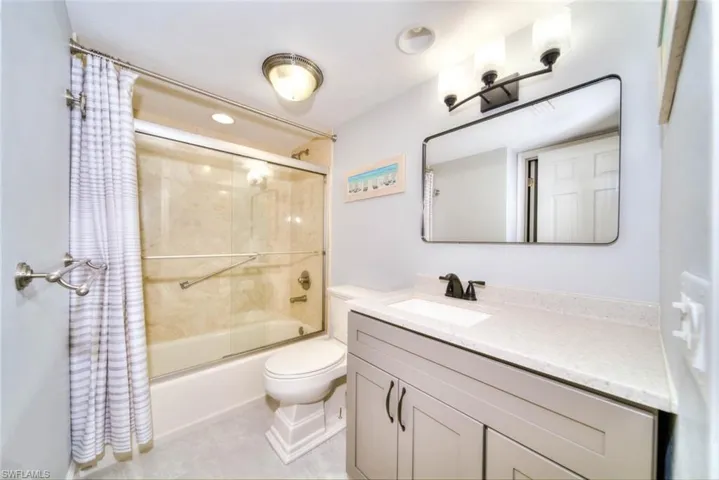 Full bathroom with vanity, toilet, and shower / tub combo