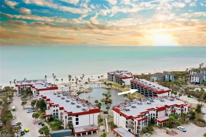 Aerial view at dusk featuring a water view